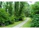 A winding walking path passes through a grassy field surrounded by mature trees at 4814 Lynton Ct, Indianapolis, IN 46254
