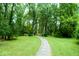 Lush greenery and a winding pathway create a serene and inviting atmosphere in this beautiful yard at 4814 Lynton Ct, Indianapolis, IN 46254