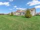 Serene backyard with lush lawn and manicured landscaping at 4993 Silverbell Dr, Plainfield, IN 46168