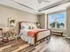 A primary bedroom featuring a tray ceiling, a ceiling fan, and a large window with a bench seat at 4993 Silverbell Dr, Plainfield, IN 46168