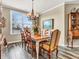 Charming dining room with natural light and a traditional chandelier at 4993 Silverbell Dr, Plainfield, IN 46168
