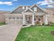 Charming single-story home featuring a covered front porch, attached garage, and well-maintained lawn at 4993 Silverbell Dr, Plainfield, IN 46168