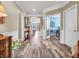 Spacious hallway with wood floors offers open access to the living areas of the home at 4993 Silverbell Dr, Plainfield, IN 46168