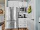 Kitchen with stainless steel refrigerator, microwave, and white cabinets at 4993 Silverbell Dr, Plainfield, IN 46168