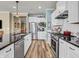 Modern kitchen featuring stainless steel appliances, white cabinets, and dark countertops at 4993 Silverbell Dr, Plainfield, IN 46168