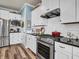 Bright kitchen with white cabinets, black countertops, and stainless steel appliances at 4993 Silverbell Dr, Plainfield, IN 46168