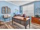 This home office features blue walls, wood-look floors, and a large window for plenty of natural light at 4993 Silverbell Dr, Plainfield, IN 46168