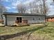 Backyard view of home with wooden deck and sliding glass door at 5105 Manning Rd, Indianapolis, IN 46228