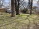Large backyard featuring mature trees and green grass at 5105 Manning Rd, Indianapolis, IN 46228