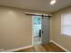 Bathroom featuring a sliding barn door leading to a new tiled shower and vanity at 5105 Manning Rd, Indianapolis, IN 46228
