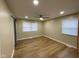 Bright bedroom with a ceiling fan, wood-look flooring, and natural light from two windows at 5105 Manning Rd, Indianapolis, IN 46228