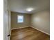 Bedroom with vinyl floors, a ceiling light, and one window providing natural light at 5105 Manning Rd, Indianapolis, IN 46228