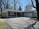 Charming single-story home with a large driveway and attached garage at 5105 Manning Rd, Indianapolis, IN 46228