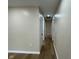 Inviting hallway with wood-look flooring and neutral paint leads to various rooms in the home at 5105 Manning Rd, Indianapolis, IN 46228