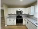 Modern kitchen with new appliances, granite countertops, and white cabinets at 5105 Manning Rd, Indianapolis, IN 46228