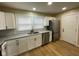 Bright kitchen featuring white cabinets, granite countertops, and stainless appliances at 5105 Manning Rd, Indianapolis, IN 46228