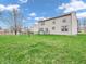 Expansive backyard with a well-maintained lawn, bordered by a classic black chain-link fence at 5524 Cherry Blossom Ct, Indianapolis, IN 46237