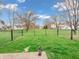 Green backyard surrounded by a black chain-link fence, offering privacy and security at 5524 Cherry Blossom Ct, Indianapolis, IN 46237