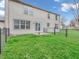 Lush green backyard with a patio and black chain-link fence, ideal for outdoor enjoyment at 5524 Cherry Blossom Ct, Indianapolis, IN 46237