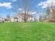 Expansive backyard with lush green grass, mature trees, and a fenced perimeter for privacy at 5524 Cherry Blossom Ct, Indianapolis, IN 46237