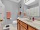 Well-lit bathroom with a single sink vanity, toilet, and shower with butterfly-themed curtain at 5524 Cherry Blossom Ct, Indianapolis, IN 46237