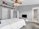 Bedroom featuring shelves, a ceiling fan, and a view of a TV and bathroom at 5524 Cherry Blossom Ct, Indianapolis, IN 46237