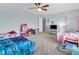 Charming bedroom featuring playful decor, two beds, and a ceiling fan at 5524 Cherry Blossom Ct, Indianapolis, IN 46237
