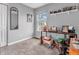 Bright bedroom with a large window, desk, and shelf for displaying photos at 5524 Cherry Blossom Ct, Indianapolis, IN 46237