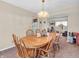 Cozy dining area with wooden table, chairs, and a view of the adjoining living room at 5524 Cherry Blossom Ct, Indianapolis, IN 46237