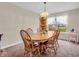 Bright dining room featuring wooden table and chairs, complemented by natural light from the window at 5524 Cherry Blossom Ct, Indianapolis, IN 46237