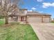Charming two-story brick and vinyl home with a three-car garage and inviting front porch at 5524 Cherry Blossom Ct, Indianapolis, IN 46237