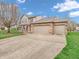 Beautiful two-story home with brick accents, a well-manicured lawn, and a three-car garage at 5524 Cherry Blossom Ct, Indianapolis, IN 46237