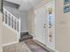 Inviting foyer with tile flooring, a staircase, and a front door with glass inserts at 5524 Cherry Blossom Ct, Indianapolis, IN 46237