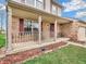 Inviting front porch with brick accents, outdoor seating, and a well-maintained garden at 5524 Cherry Blossom Ct, Indianapolis, IN 46237