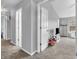 Hallway featuring gray walls, neutral carpet, and a view into a bedroom with gray furniture at 5524 Cherry Blossom Ct, Indianapolis, IN 46237