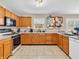 Functional kitchen with wood cabinets, tile flooring, and essential appliances at 5524 Cherry Blossom Ct, Indianapolis, IN 46237