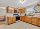 Well-lit kitchen featuring wood cabinets, tile floors, and ample counter space at 5524 Cherry Blossom Ct, Indianapolis, IN 46237
