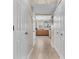 Hallway view of the kitchen featuring tile floors, ample cabinet space, and natural light at 5524 Cherry Blossom Ct, Indianapolis, IN 46237