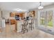 Charming kitchen with wooden cabinets, tile floors, breakfast bar, and sliding glass doors to backyard at 5524 Cherry Blossom Ct, Indianapolis, IN 46237