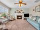Inviting living room boasts a fireplace, neutral walls, a ceiling fan, and comfortable seating at 5524 Cherry Blossom Ct, Indianapolis, IN 46237