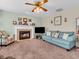 Comfortable living room with a fireplace, carpet, and ample seating, creating a welcoming atmosphere at 5524 Cherry Blossom Ct, Indianapolis, IN 46237
