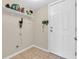 Functional mud room with tiled floor, built-in shelf, and convenient access to the exterior at 5524 Cherry Blossom Ct, Indianapolis, IN 46237