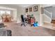 A home office with a wooden desk, black leather chair, and views of the dining room and stairway at 5524 Cherry Blossom Ct, Indianapolis, IN 46237