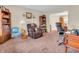 Bright office area with a spacious desk, a chair, and adjacent to a comfortable relaxation area at 5524 Cherry Blossom Ct, Indianapolis, IN 46237
