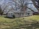 Side view of the brick home with a well-maintained lawn and mature trees at 5961 N 200 W, Columbus, IN 47201