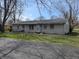 Modest one-story brick home with a cozy feel and a sprawling front yard at 5961 N 200 W, Columbus, IN 47201