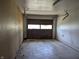 Picture of a garage with concrete floor and a partially open door, offering ample parking space at 5961 N 200 W, Columbus, IN 47201