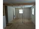 Open-concept space with a window for natural light; wiring exposed awaiting new fixtures at 5961 N 200 W, Columbus, IN 47201
