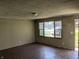 Bright living room featuring laminate floors and a large window letting in natural light at 5961 N 200 W, Columbus, IN 47201