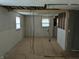 Another view of the unfinished room with plywood subfloor and multiple windows at 5961 N 200 W, Columbus, IN 47201